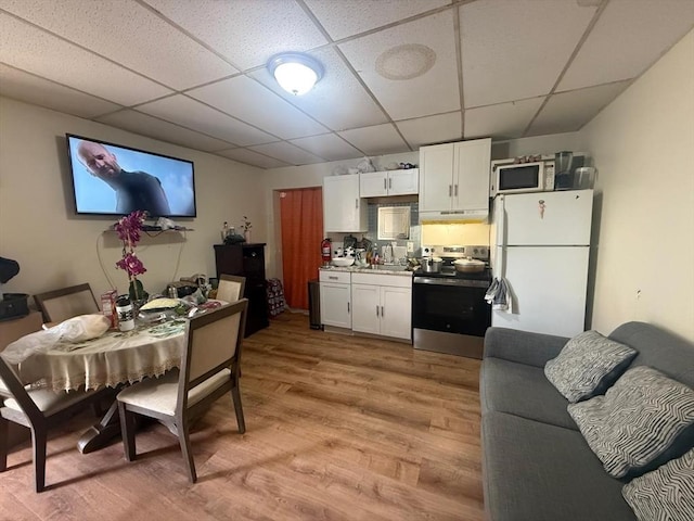91 Summer St Unit 3, Lawrence, MA 01840 - kitchen with white appliances, a drop ceiling, light wood-style floors, white cabinetry, and a sink