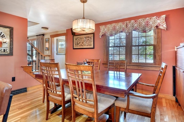 dining space featuring light wood-type flooring