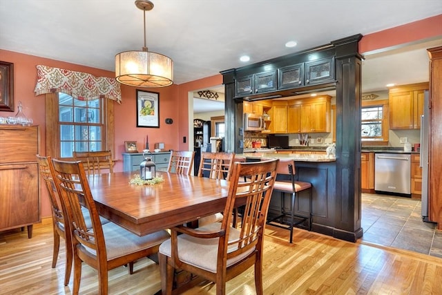 dining space with light hardwood / wood-style floors