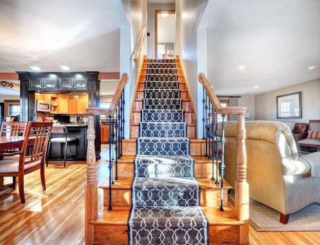 staircase with hardwood / wood-style floors