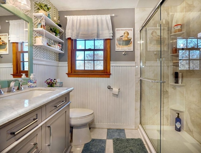 bathroom featuring vanity, an enclosed shower, and toilet