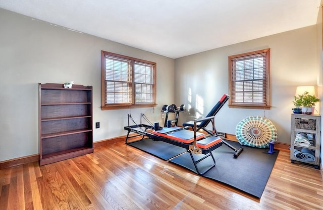 workout room with light hardwood / wood-style floors