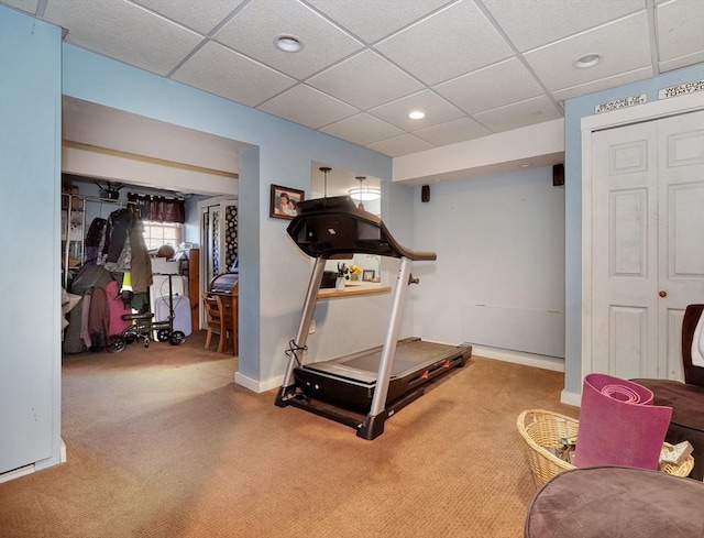 exercise room with carpet and a drop ceiling