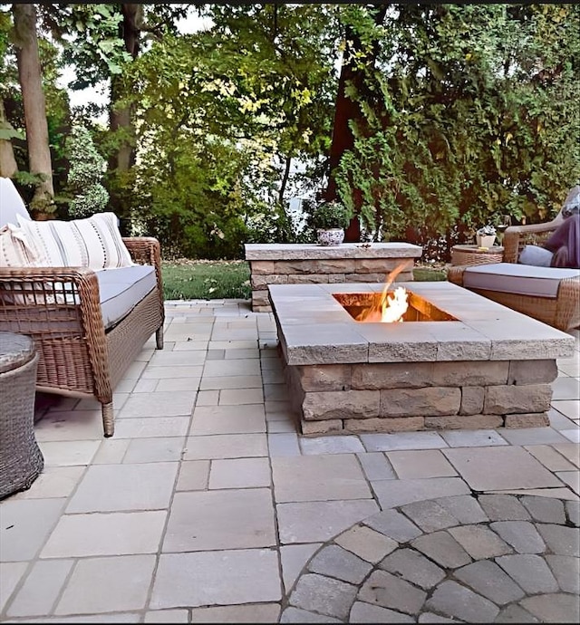 view of patio / terrace with an outdoor living space with a fire pit