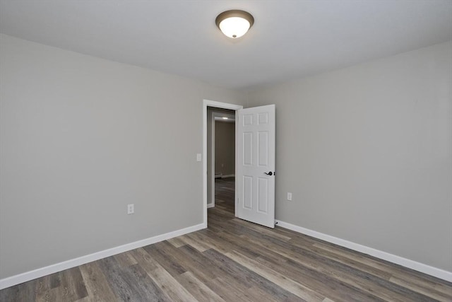 unfurnished room featuring dark hardwood / wood-style flooring