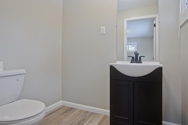 bathroom with vanity, hardwood / wood-style flooring, and toilet