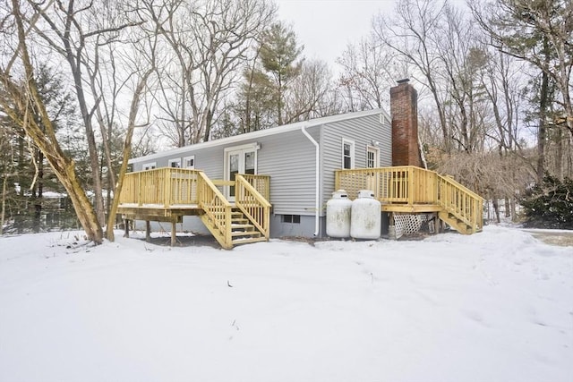 snow covered property with a wooden deck