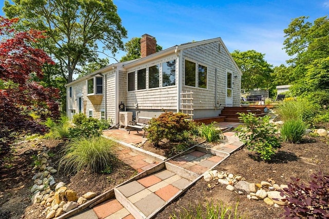 6 Paddock Dr, Harwich, MA 02645 - view of front of property featuring a chimney and a patio area