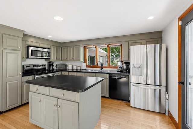 6 Paddock Dr, Harwich, MA 02645 - kitchen featuring appliances with stainless steel finishes, dark countertops, light wood-style flooring, a kitchen island, and recessed lighting