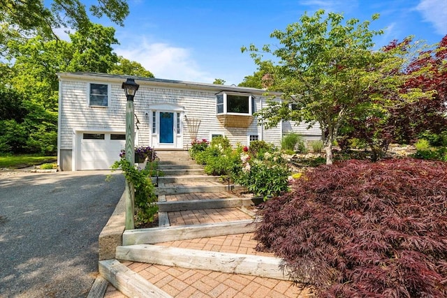 6 Paddock Dr, Harwich, MA 02645 - bi-level home with an attached garage and driveway