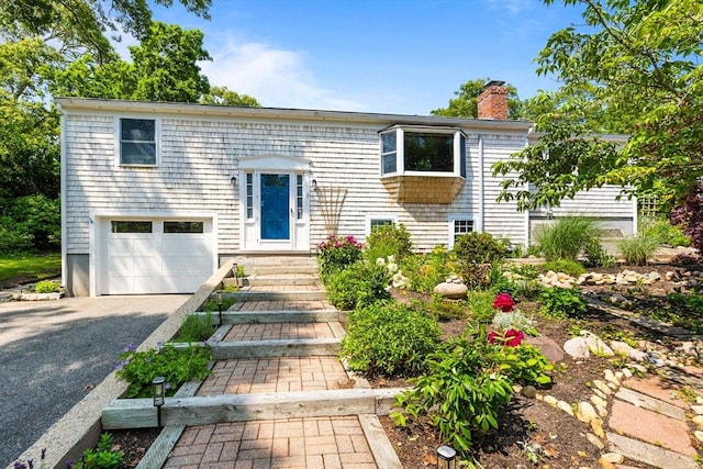 6 Paddock Dr, Harwich, MA 02645 - raised ranch with a chimney, a garage, and driveway