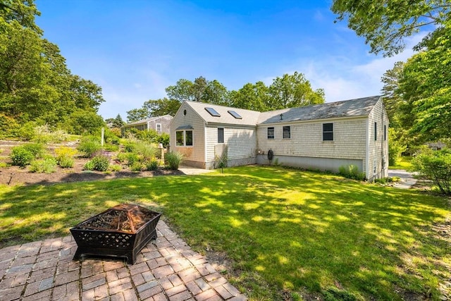 6 Paddock Dr, Harwich, MA 02645 - rear view of property featuring a fire pit, a yard, and a patio