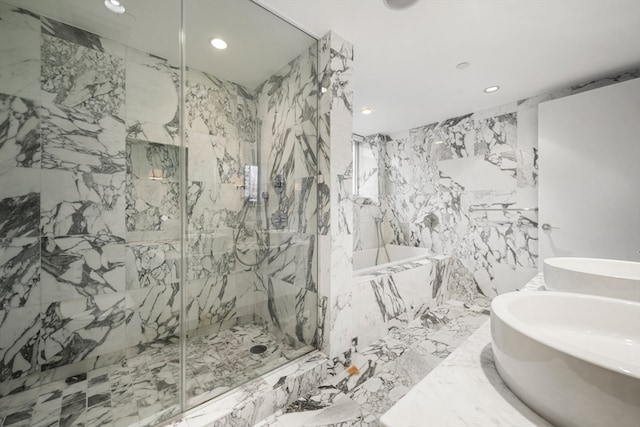 bathroom with tile flooring, separate shower and tub, and tile walls