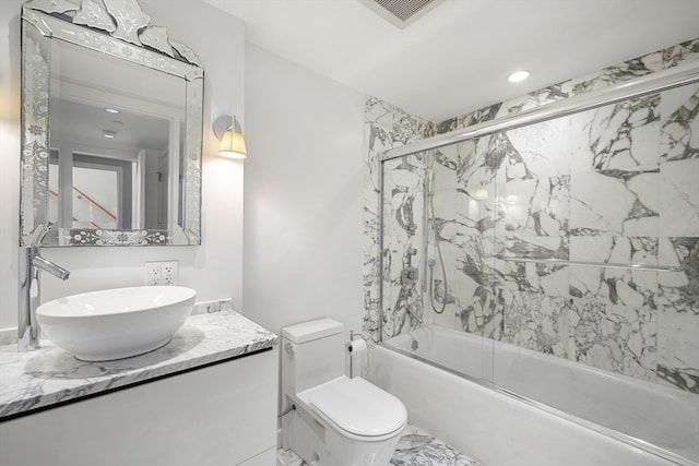 full bathroom featuring vanity, toilet, and enclosed tub / shower combo