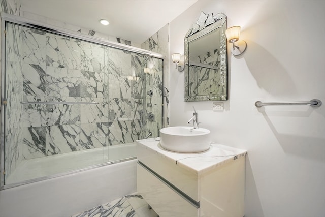 bathroom featuring tile floors, large vanity, and combined bath / shower with glass door