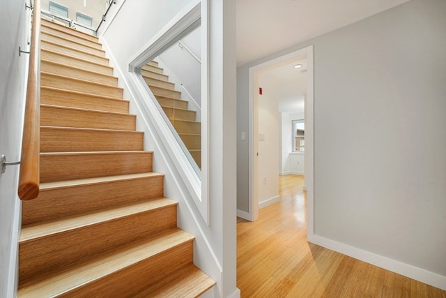 staircase with light hardwood / wood-style floors