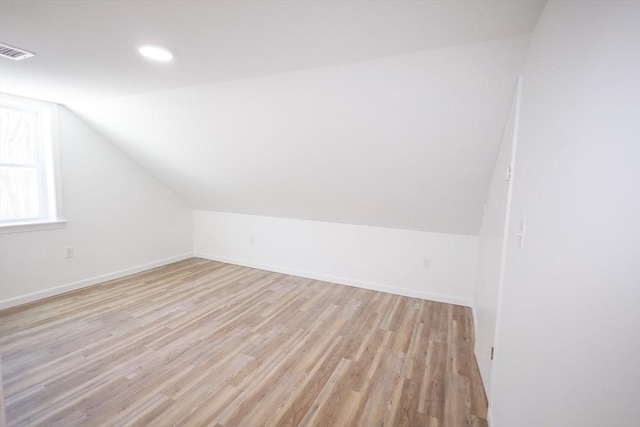 bonus room featuring vaulted ceiling and light hardwood / wood-style floors