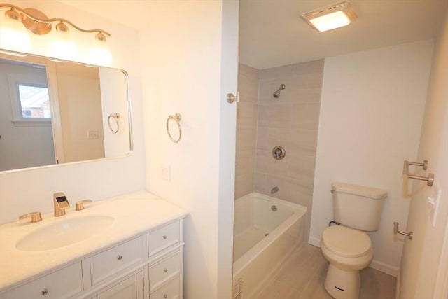 full bathroom with vanity, tiled shower / bath combo, and toilet