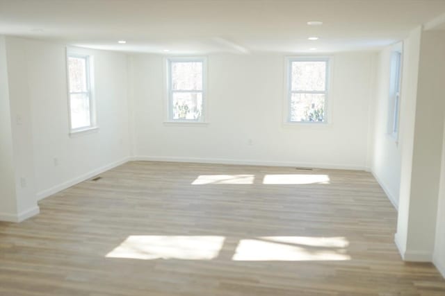 empty room with light hardwood / wood-style floors