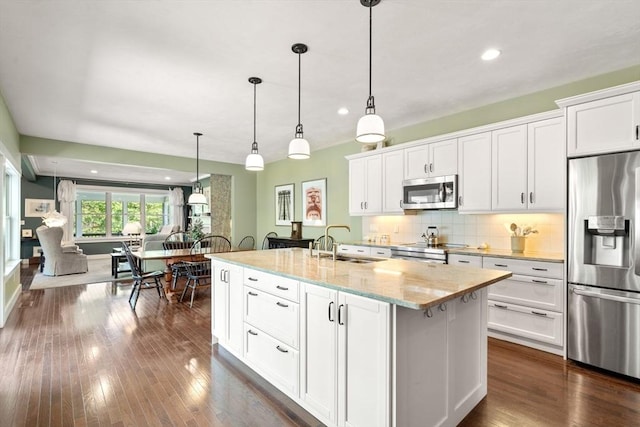 40 Tall Pine Dr Unit 18, Sudbury, MA 01776 - kitchen featuring appliances with stainless steel finishes, white cabinetry, decorative backsplash, dark wood-style floors, and recessed lighting