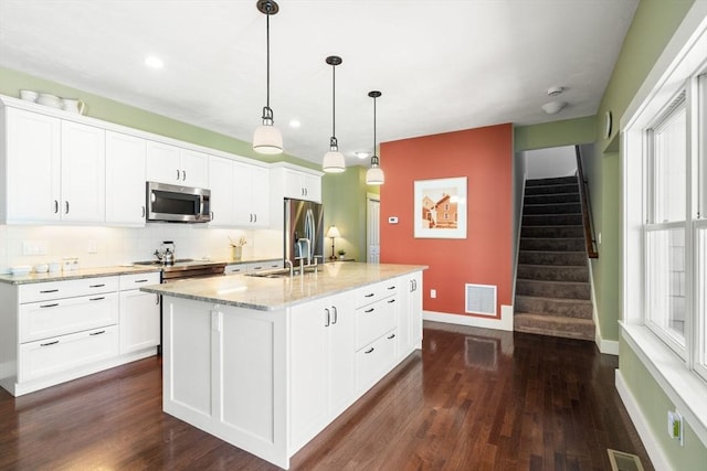 40 Tall Pine Dr Unit 18, Sudbury, MA 01776 - kitchen with stainless steel appliances, dark wood-style flooring, white cabinetry, backsplash, and recessed lighting