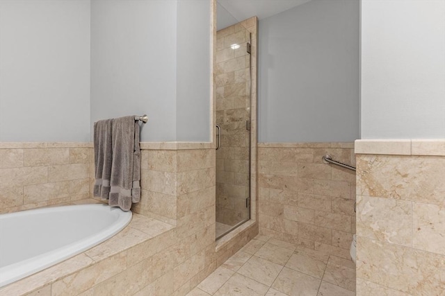 bathroom with separate shower and tub