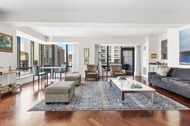 living room with dark parquet floors and a healthy amount of sunlight