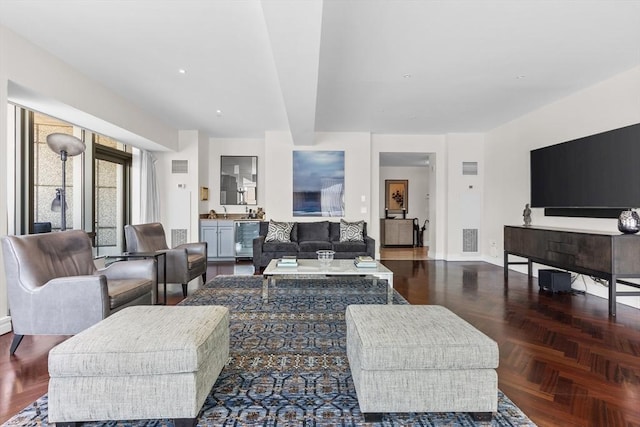 living room featuring dark parquet flooring and wine cooler