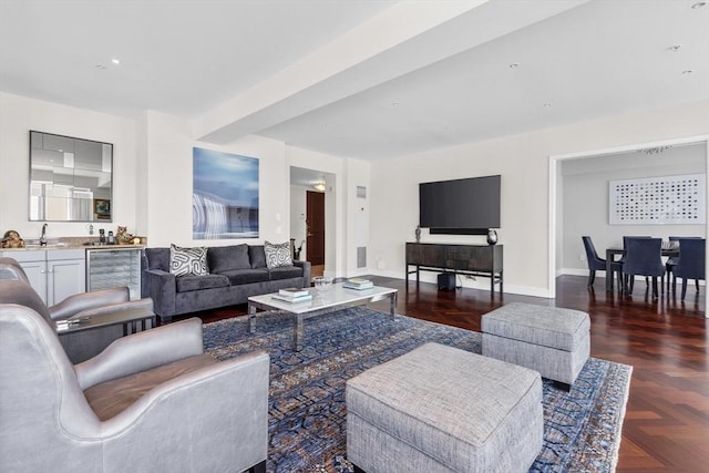 living room featuring dark parquet flooring, sink, and beverage cooler