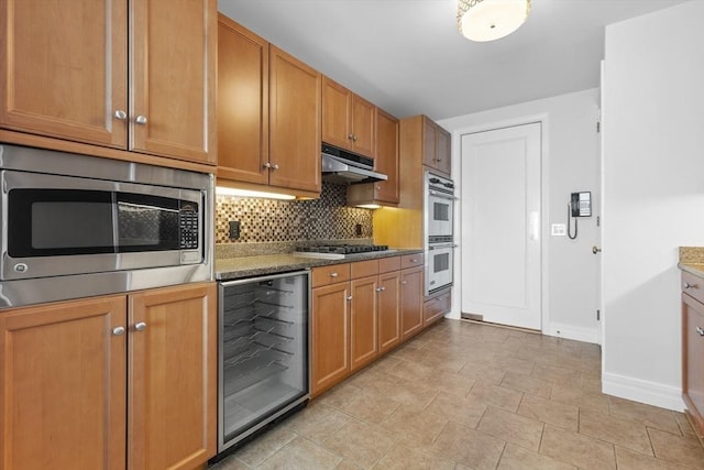 kitchen with stone counters, appliances with stainless steel finishes, tasteful backsplash, and wine cooler