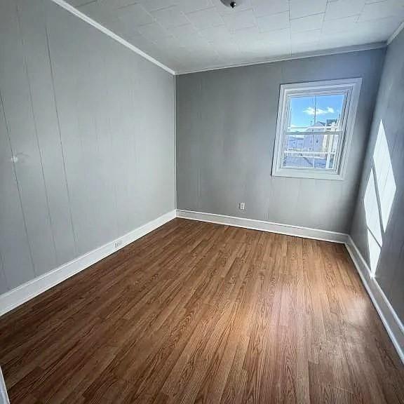 173 County St, Fall River, MA 02723 - empty room featuring dark wood finished floors and crown molding