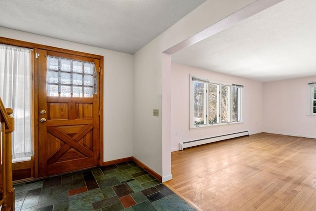 entrance foyer featuring a baseboard radiator, dark wood-type flooring, and a wealth of natural light