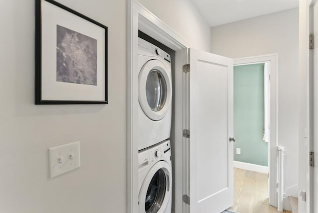 54-58 Robey St Unit 54, Boston, MA 02119 - laundry area featuring stacked washer and clothes dryer, wood finished floors, and baseboards
