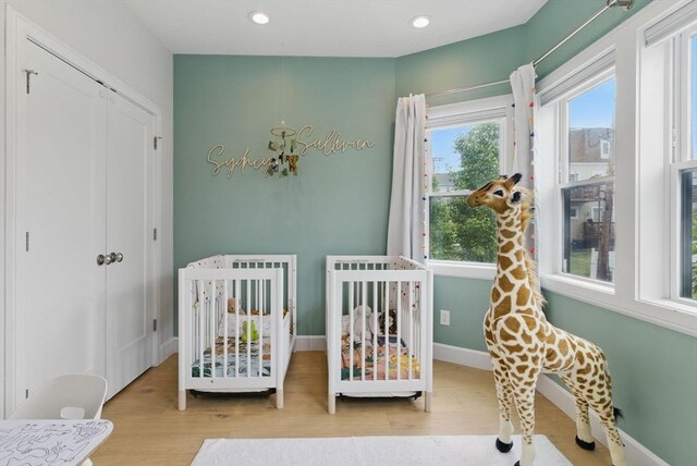 54-58 Robey St Unit 54, Boston, MA 02119 - bedroom featuring wood finished floors, a closet, baseboards, a nursery area, and recessed lighting