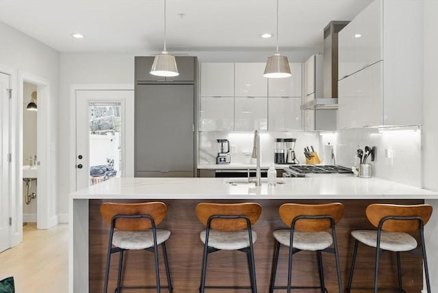 54-58 Robey St Unit 54, Boston, MA 02119 - kitchen featuring modern cabinets, a sink, light countertops, wall chimney exhaust hood, and a peninsula