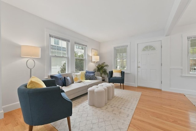 living area with light wood-type flooring and baseboards