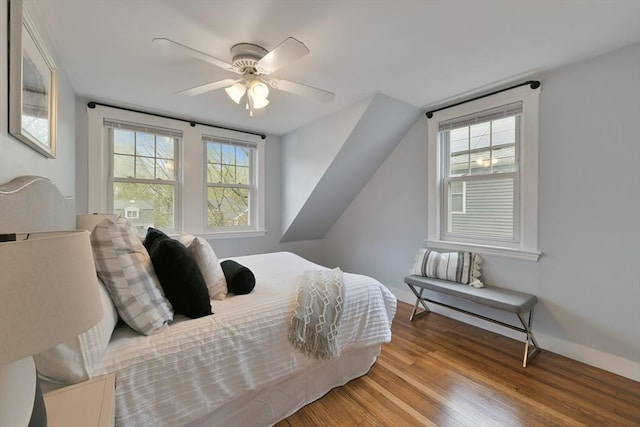 bedroom featuring baseboards, ceiling fan, and wood finished floors