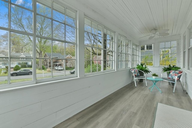 sunroom / solarium featuring a ceiling fan