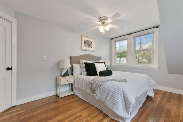 bedroom with ceiling fan, hardwood / wood-style flooring, and baseboards