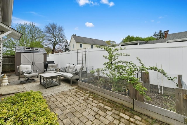 view of patio / terrace featuring outdoor lounge area, an outdoor structure, a storage shed, a garden, and a fenced backyard