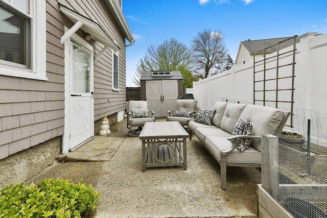 view of patio / terrace featuring a fenced backyard, a storage shed, outdoor lounge area, and an outbuilding