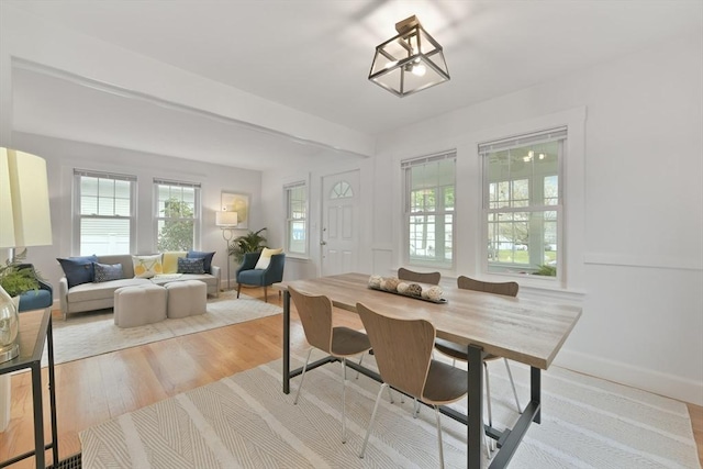 dining space with wood finished floors and baseboards