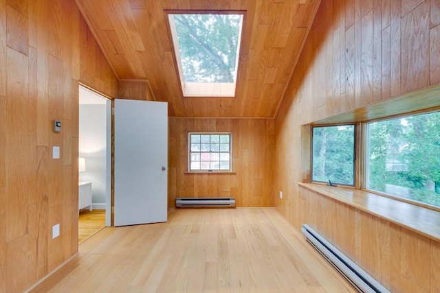 interior space featuring a baseboard radiator, wooden ceiling, a baseboard heating unit, wooden walls, and vaulted ceiling with skylight