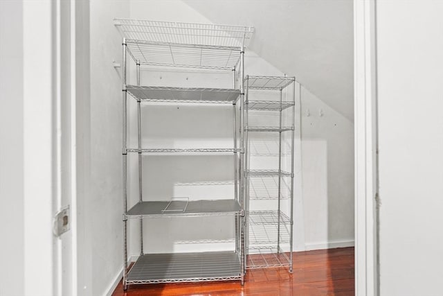 spacious closet featuring wood finished floors and lofted ceiling