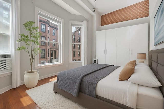 bedroom featuring baseboards and wood finished floors