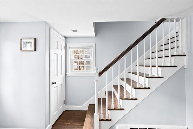 stairway featuring baseboards and wood finished floors
