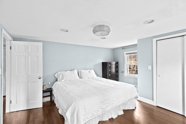 bedroom with baseboards and dark wood-style floors