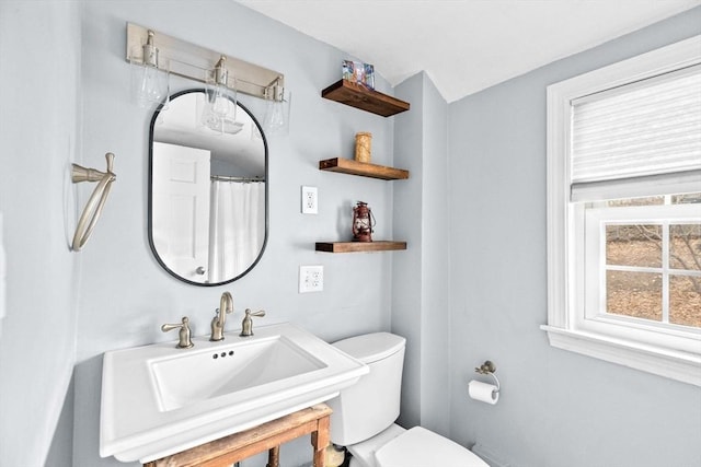 full bath with toilet and a sink