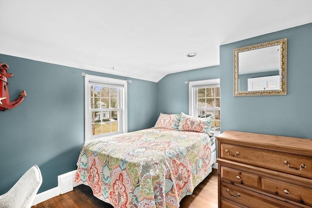 bedroom featuring baseboards, vaulted ceiling, and dark wood-style flooring