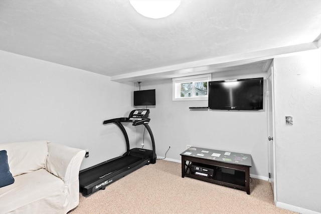 workout room with baseboards and carpet